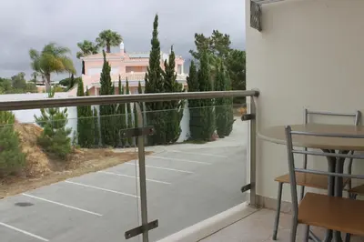 a kitchen with wooden cabinets and a counter top at AP Casa Monte da Balaia in Albufeira
