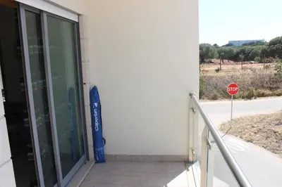 a balcony with a view of a tennis court at AP Casa Monte da Balaia in Albufeira