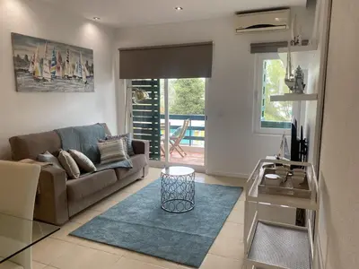 a living room with a couch and a table at Neptuno IV - Vilamoura in Quarteira