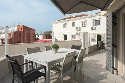 a patio with a table and chairs on a balcony at Marina Luxor - Vilamoura in Quarteira