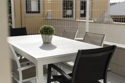 a white table with a potted plant on it at Marina Luxor - Vilamoura in Quarteira