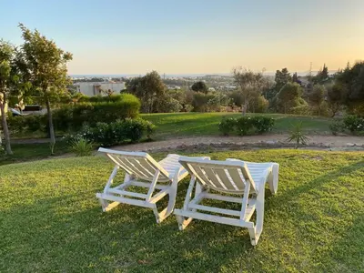 two white chairs sitting on top of a lawn at Wonderful View - Quinta da Colina C8 in Albufeira