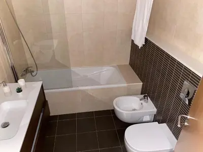 a bathroom with a toilet and a tub and a sink at Wonderful View - Quinta da Colina C8 in Albufeira