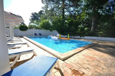 a living room with a red couch and a fireplace at Fantastic outdoor area, private pool, Tennis Court Golf Practice Facility in Faro