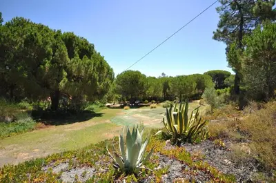 a swimming pool with white poles around it at Fantastic outdoor area, private pool, Tennis Court Golf Practice Facility in Faro