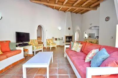 a bedroom with a bed and a couch in a room at Fantastic outdoor area, private pool, Tennis Court Golf Practice Facility in Faro