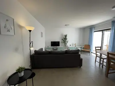 a living room with a couch and a table at Vila Flor - Vilamoura in Vilamoura
