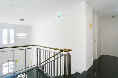 a staircase in a building with a white wall at Casa Amarela Guesthouse in Albufeira