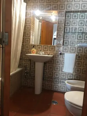 a bathroom with a sink and a toilet and a mirror at Comfortable Appartment at Albufeira in Albufeira