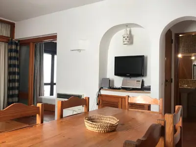 a living room with a table and a television at Comfortable Appartment at Albufeira in Albufeira