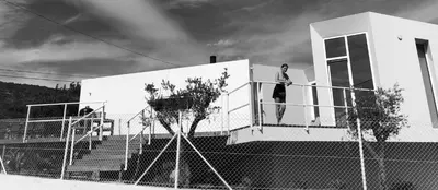 a man standing on the balcony of a house at Boutique Hotel - Casa Esteval in Rocha Amarela
