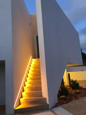 a staircase leading up to a house with a white wall at Boutique Hotel - Casa Esteval in Rocha Amarela