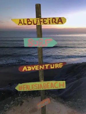 a wooden sign with arrows on the beach at Boutique Hotel - Casa Esteval in Rocha Amarela