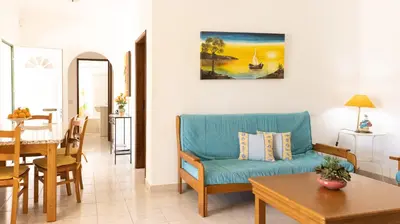 a living room with a blue couch and a table at Villa Monte Bixo - Free WIFI . Swimmning Pool - BY BEDZY in Assumadas