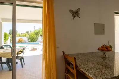 a dining room with a table and a butterfly on the wall at Villa Monte Bixo - Free WIFI . Swimmning Pool - BY BEDZY in Assumadas