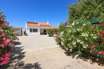 a house with flowers in front of a driveway at Villa Monte Bixo - Free WIFI . Swimmning Pool - BY BEDZY in Assumadas