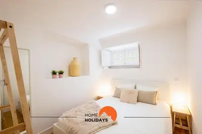 a white bedroom with a bed with pillows and a window at #049 Villa Lemon by Home Holidays in Albufeira