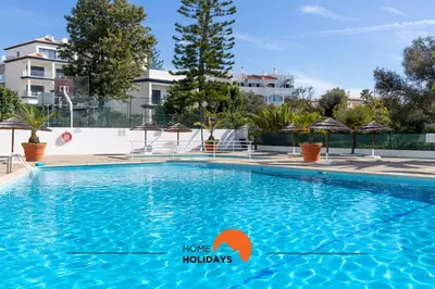 a bedroom with a bed with an orange arrow pointing to home holidays at #048 Sunrise by Home Holidays in Vale de Pedras
