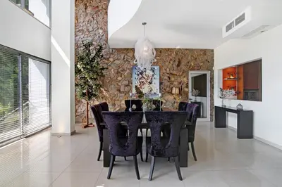 a dining room with a table with purple chairs at Villa Rosana in Albufeira
