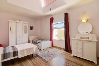 a bedroom with a bed and a dresser and a window at Villa Rosana in Albufeira