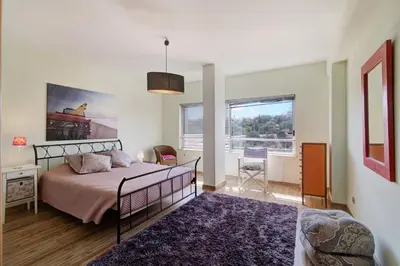 a bedroom with a bed and a large window at Villa Rosana in Albufeira