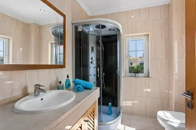 a bathroom with a sink and a shower at Villa Carvalho by Villa Plus in Albufeira