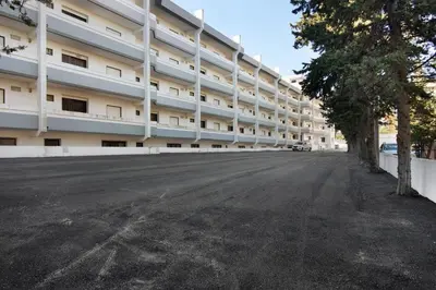 an empty street in front of a large building at T2 Balaia in Albufeira