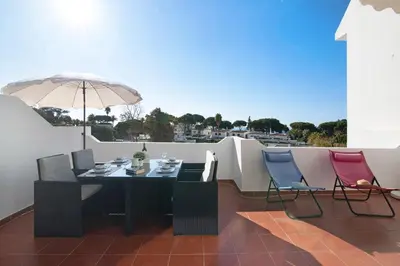 three chairs and a couch on a balcony at T2 Balaia in Albufeira