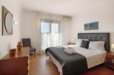 a hotel room with two beds and a window at T2 Balaia in Albufeira