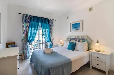 a bedroom with a bed with a teddy bear on it at T2 Bosque de São José in Albufeira