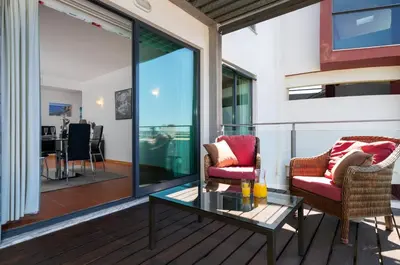 a living room with two chairs and a glass table at RESIDENCE GOLF CLUB by Intiholidays in Vilamoura
