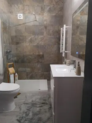a bathroom with a toilet and a sink and a tub at Apartamento Recanto do Avô in Albufeira