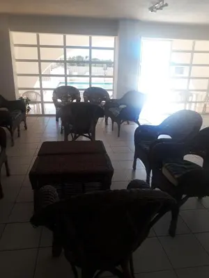 a waiting room with chairs and tables and a window at studio para 2 pessoas in Albufeira