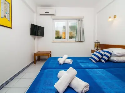 a bedroom with a blue bed with towels on it at Old Town Apartment by Stay ici Algarve Holiday Rental in Albufeira