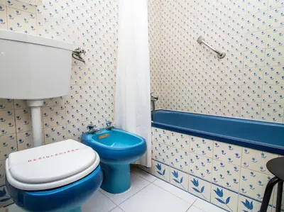 a bathroom with a blue toilet and a shower at Old Town Apartment by Stay ici Algarve Holiday Rental in Albufeira