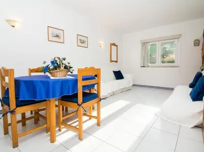 a living room with a table and a bed at Old Town Apartment by Stay ici Algarve Holiday Rental in Albufeira