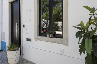 a door with a window and potted plants on it at Casa da Praca - City Center - Faro in Faro