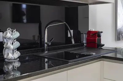 a kitchen with a sink and a counter top with a sink at Casa da Praca - City Center - Faro in Faro