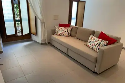 a living room with a couch with pillows on it at Janelas Verdes 37 in Faro