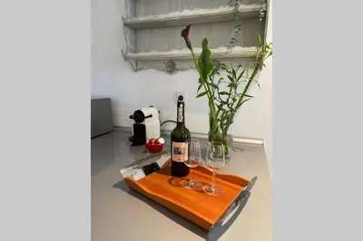 a table with two glasses and a bottle of wine at Janelas Verdes 37 in Faro
