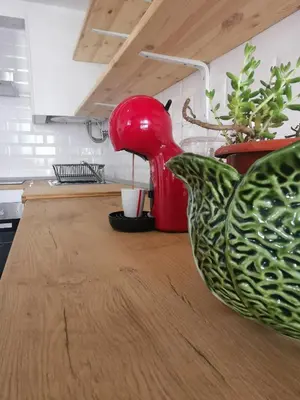 a red mixer sitting on top of a kitchen counter at Tiny House Faro in Faro