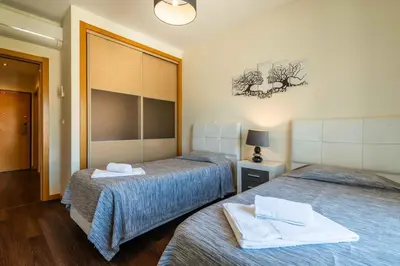 a room with two beds with towels on them at T2 Eucalipto 2A by Algarneto in Olhos de Água