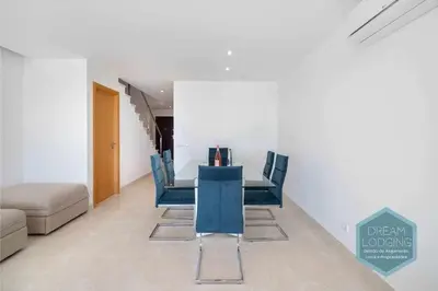 a dining room with a table and blue chairs at Patroves Sea View - Dream Lodging in Albufeira