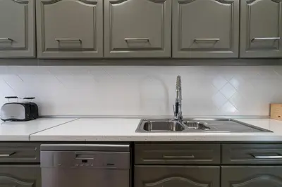 a kitchen counter with a sink and a appliance at Villa Macuti by SAPvillas in Vilamoura