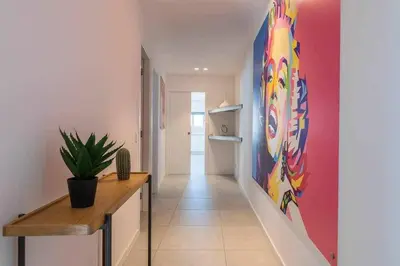 a hallway with a painting on the wall at Central Town 2-Bedroom Apartment Albufeira in Albufeira