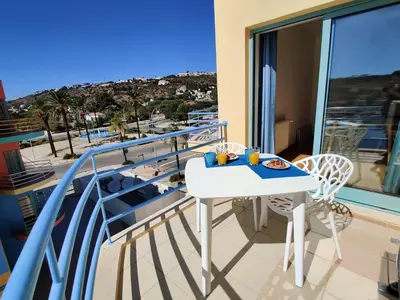 a balcony with a table and chairs and a view at Albufeira Marina Views in Albufeira