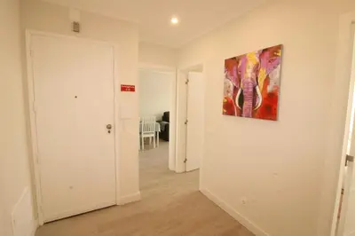 a hallway with a painting hanging on a wall at Downtown Dreams in Faro