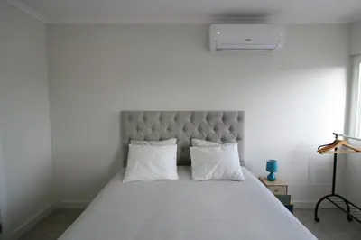 a bedroom with a large bed with white sheets and pillows at Downtown Dreams in Faro