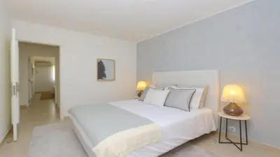 a white bedroom with a large bed and two lamps at Vila Chez Lee, 219 Aldeia do Golf-CleverDetails - Sleeps 6, quiet area in Vilamoura