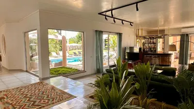 a living room with a couch and a pool at Seventies by Check-in Portugal in Quarteira